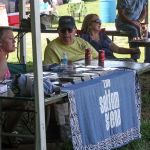 Ben Eldridge at the merch table with Seldom Scene at the August 2016 Gettysburg Bluegrass Festival - photo by Frank Baker