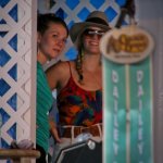 Celia and Shelby from Della Mae check out Dailey & Vincent from backstage at Delaware Valley (September 2012) - photo by Frank Baker