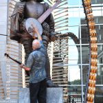 Pete Wernick checks Sir Walter's tuning at World of Bluegrass 2016 - photo © Bill Warren