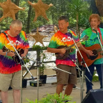 Shin Akimoto playing Akira's Otsuka's mandolin upside down, Akira Otsuka on Shin's left handed mandolin and Josh Otsuka on guitar at the 2016 Takarazuka Festival - Photo by Yoshimi Isoyama