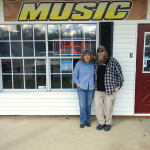 Enola and Jimmy Haynes out in front of their shop