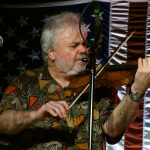 Rickie Simpkins with The Seldom Scene at the 2016 Musicians Against Childhood Cancer festival - photo by Daniel Mullins