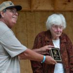 Bill Warren inducts Virgie McClearen into the Southeast Michigan Bluegrass Music Association Hall of Honor at the 2016 Milan Bluegrass Festival when rain shut down the stage show