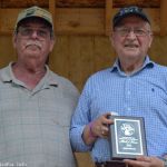 Bill Warren inducts John Morris into the Southeast Michigan Bluegrass Music Association Hall of Honor at the 2016 Milan Bluegrass Festival when rain shut down the stage show