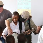 South African schoolchild tries out the banjo during a visit from the 2012 Banjo Safari crew - photo by Kevin Dooley