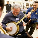 Dick Smith (left) plays with Buddy Wachter (center) on a tenor All-American as Frank Schoepf (right) watches at Banjothon 2013 - photo © Dean Hoffmeyer