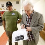 Curtis McPeake signing a poster for Phillip Bostic at Banjothon 2013 - photo © Dean Hoffmeyer