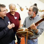 Joey Evans, Dave Hedrick and Gene Knight look at an RB-3 wreath at Banjothon 2013 - photo © Dean Hoffmeyer