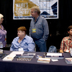 Kitty Kuykendall, Katy Daly, Lee Michael Demsey, and Brad Kolodner at the WAMU booth at World of Bluegrass 2015 - photo by Becky Johnson