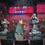 Late Show stage manager Biff Henderson walks by while Pete Wernick looks busy during the Steve Martin/LRB sound check