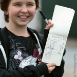 Happy young lady with autographs from Della Mae at The Festy 2013 - photo © Gina Elliott Photographer