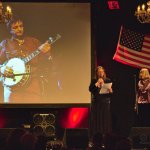 Angelika Torrie and Susie Bowe presenting a 2015 European Bluegrass Pioneer Award to Jean-Marie Redon (3/14/15) - photo by Robert Bowe