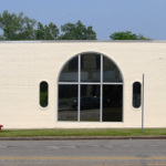 Custom mural being painted on the face of the Elderly Instruments building in Lansing, MI