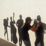 Custom mural being painted on the face of the Elderly Instruments building in Lansing, MI
