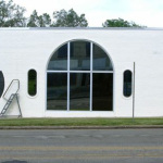 Custom mural being painted on the face of the Elderly Instruments building in Lansing, MI