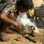 Burning holes for sarangi tuners the old time way - photo by Tara Linhardt