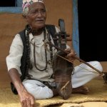 Mohan Gandharb plays sarangi and arboj and tell stories on a mat his wife made at his house - photo by Tara Linhardt