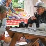 Irene Lehman and Garland Gobble swap stories at the May 2016 Gettysburg Bluegrass Festival - photo by Frank Baker