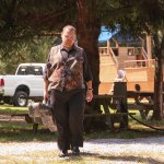 Junior Sisk heading for the stage with his camo guitar case at the Gettysburg Bluegrass Festival (August 2014) - photo by Frank Baker