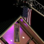 US flag and a portrait of Houston Caldwell fly at Houstonfest 2013 - photo by Andy Garrigue