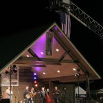 US flag and a portrait of Houston Caldwell fly at Houstonfest 2013 - photo by Andy Garrigue
