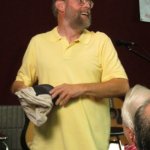 Dana Bourgeois giving away swag at the Bourgeois Flatpicking Jam at World of Bluegrass 2012 - photo by Woody Edwardsana