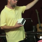 Dana Bourgeois giving away swag at the Bourgeois Flatpicking Jam at World of Bluegrass 2012 - photo by Woody Edwards