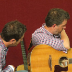 Keith Sewell and Bryan Sutton watching Shin Ichikawa at the Bourgeois Flatpicking Jam at World of Bluegrass 2012 - photo by Woody Edwards