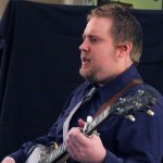 Keith McKinnon warming up with IIIrd Tyme Out at Joe Val 2014 - photo by Brance Gillihan