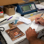 Gary Brewer leaves a note for Larry Sparks in his Mapes Guitar Strings order - photo by Alyssa Brewer