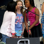Students from Greynolds Park Elementary perform with Newtown at the Everglades Bluegrass Festival - photo by Doris Schenk
