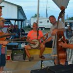 Harbourtown with fiddler Isaac Smith playing a little music for early arrivals at the 2016 Norwalk Music Festival - photo © Bill Warren