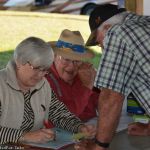 Promoters Norman and Judy Adams taking reservations for next year's show at the 2016 February Palatka Bluegrass Festival - photo © Bill Warren