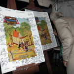 Del McCoury signs the posters backstage at the 2015 Red, White & Bluegrass Festival - photo © Laura Tate Photography