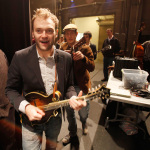 Chris Thile and Chris Eldridge slide past David Morris to perform at the Sizemore Benefit Show in Roanoke (2/19/12) - photo © Dean Hoffmeyer