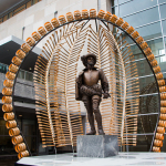 Sir Walter Raleigh statue with the Banjo Stand exhibit at the 2015 World of Bluegrass - photo © Tara Linhardt