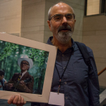 John Reischman with his new Bill Monroe photo at World of Bluegrass 2015 - photo © Tara Linhardt