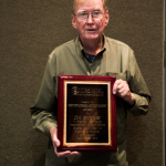 Jim Rooney with his Distinguished Achievement Award at the 2016 Wold of Bluegrass - photo © Tara Linhardt