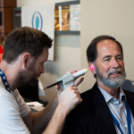 Alex Stewart from Event Tech Services fitting custom ear plugs for Wayne Taylor√