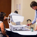 Cindy Baucom gets a free vision check at World of Bluegrass 2016 - photo by Tara Linhardt