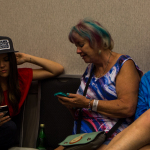 Jenni Lyn Gardner checks messages at World of Bluegrass 2016 - photo by Tara Linhardt