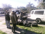 Members of the Henhouse Prowlers, with gear unloaded, look on as “Russell, the tow truck guy” hitches their van after it broke down en route to the Battle for the Boat competition on Mountain Song at Sea. Fortunately, the band made it in time to sail and went on to win the contest. -Photo by Ben Wright
