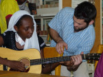 Starr Moss gives guitar pointers to a young student in Maradi