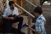 Chris Henry jamming with a young picker onstage at the 2015 Newell Lodge Bluegrass Festival - photo © Bill Warren