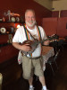 Ewell Ferguson holding Pastor Mike's mandolin