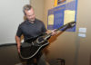 IBMM Executive Director Chris Joslin with Tom T. Halls black Ovation guitarl at the International Bluegrass Music Museum's Tom T. & Dixie Hall exhibit - photo by Alan Warren